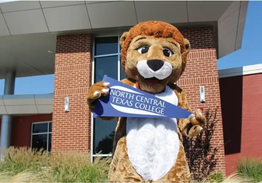 NCTC lion mascot holding college pennant