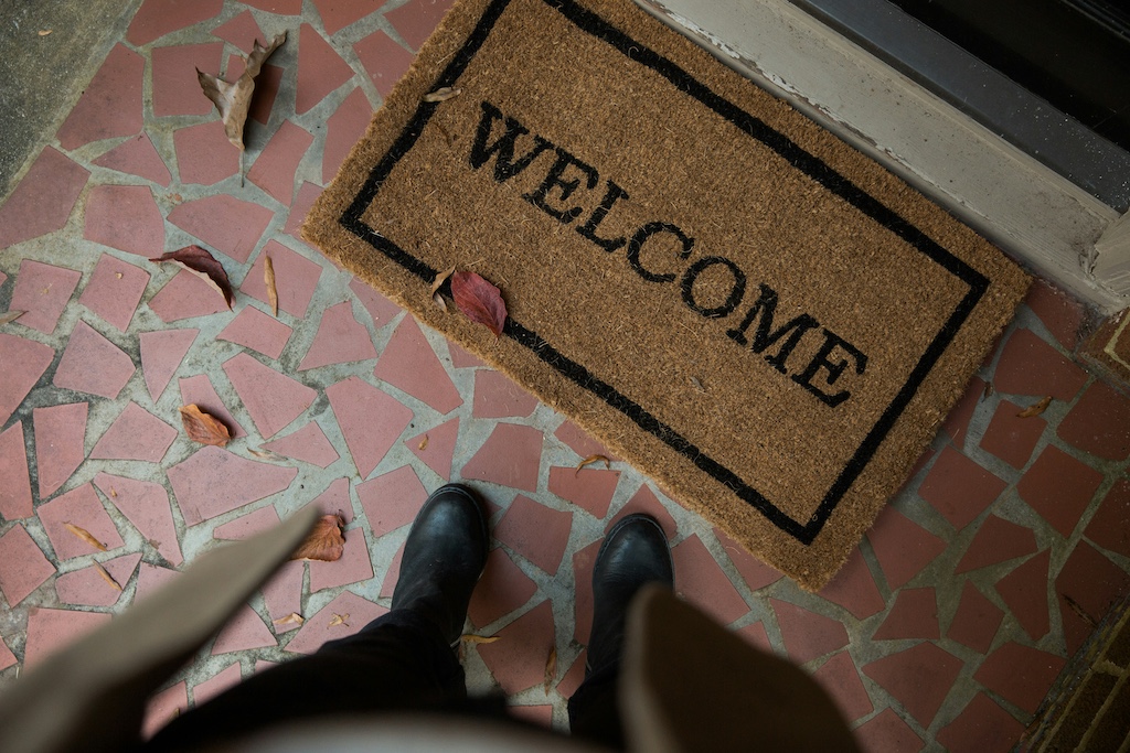feet standing by welcome mat